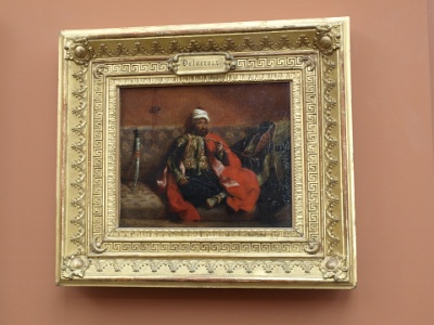 Turc Fumant, Assis Sur un Divan by Eugene Delacroix.JPG